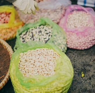 A variety of legumes, including lentils, chickpeas, and black beans, displayed in bowls
