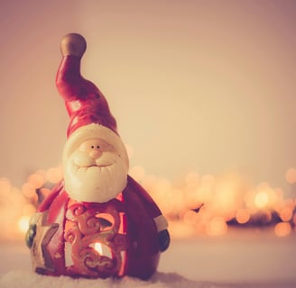 An image of Santa Claus flying through the night sky with his reindeer, delivering gifts to children