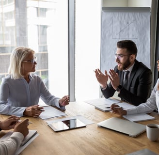 A team of legal professionals discussing fractional executive solutions for law firm management.