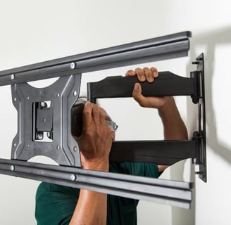 Man holding a tv mount for Morgan Hill TV installation.