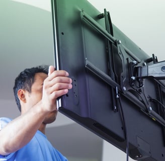 Man doing TV wall mounting for Morgan Hill TV installation.