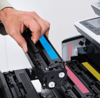 a man in a suit is holding a printer