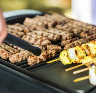 a person is cooking on a grill with skewers