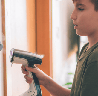 a boy is holding a hair dryer