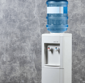 a water bottle with a water dispenser on top of it