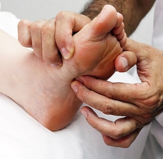 Reflexology pressing the Kidney 1 spot on the foot 