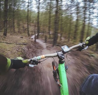 first person bike riding through a forest