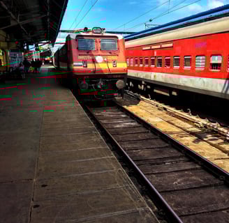 a red train is parked at a train station