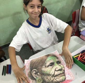 Criança criando lambe-lambe – Aluno da Escola Municipal Moreira Cabral trabalha em uma colagem