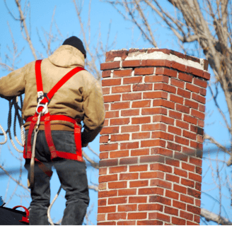 Man on roof chimney repair