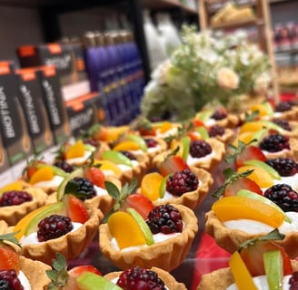 a variety of desserts on display in a store