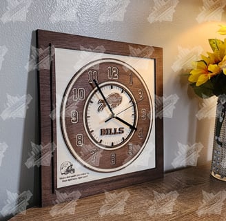 a wooden multi-layered  maple and mahogany football themed clock on a table with a vase of flowers