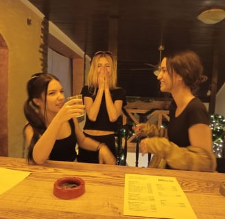 3 girls behind a bar