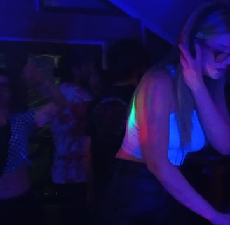 a woman in a white shirt mixing music