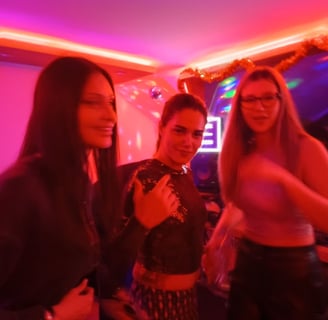 a group of women standing around a DJ pult