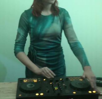 a woman in a green dress and headphones on a table