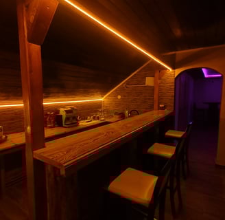 a bar with stools and stools in a room