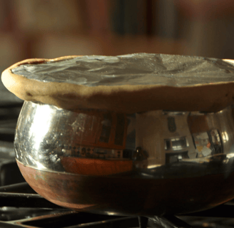 a potted potted with a saucer on top of a stove