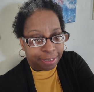 Image of Traci Joy smoling and facing the camera.