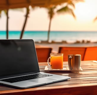 a laptop computer sitting on a table facing a beach