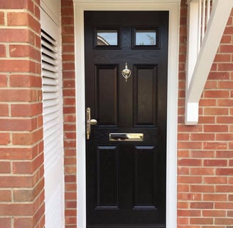 a black front door on red brick house which was fitted by Buildmydoor in Gosport