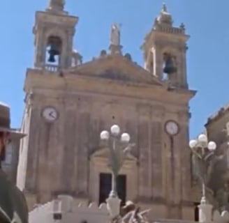 A man in a hat painting a church.