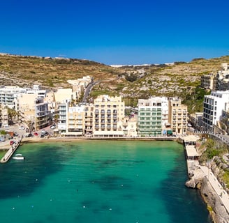 Aerial view of Xlendi Bay from high above the water. 