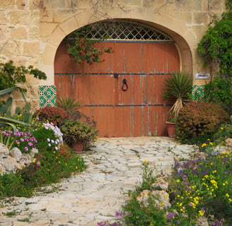 Doubled width arched door in a traditional limestone building. 