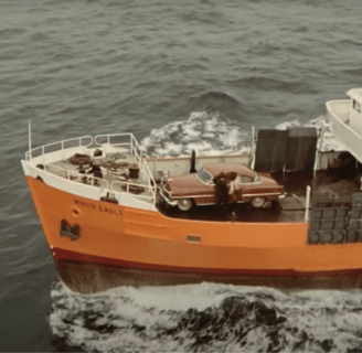 A large orange boat in the water.