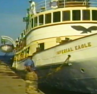 A boat moored next to a dock.