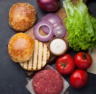 hamburger buns with purple onions, lettuce and tomatoes