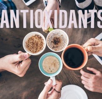 a group of people holding coffee cups with the words antioxidants