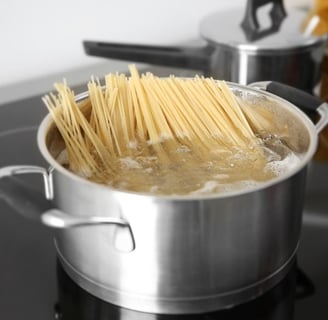 a pot boiling with spaghetti noodles