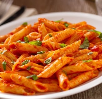 a plate of pasta with a red sauce