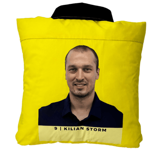 a yellow shirted pillow with a printed portrait on the back