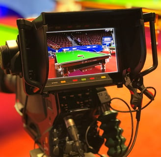 A close-up of a television camera monitor displaying a live feed of a snooker table at the World Snooker Championship..