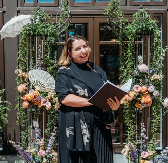 Photo of Officiant in fron of Floral Arbor