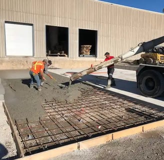 a man is pouring concrete into a concrete slab