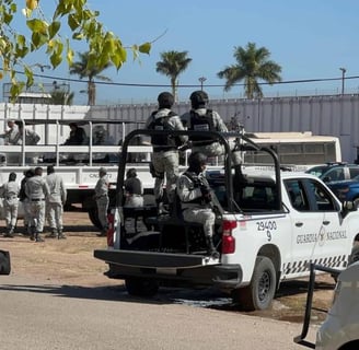 a group of soldiers are gathered around a truck