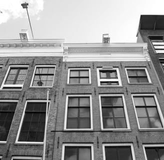 a black and white photo of a building with windows