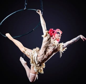 a woman in a costume is performing a trick on a hoople