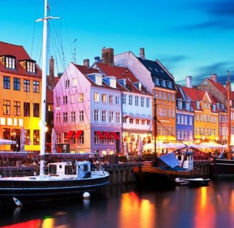 a boat docked in a harbor with a city in the background