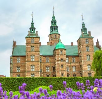 a castle like building with a green roof and a green roof