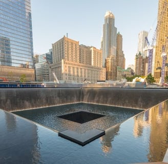 a square shaped fountain with a square shaped object in the middle