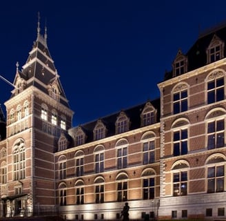 rijksmuseum - a large building with a clock tower in the middle of it