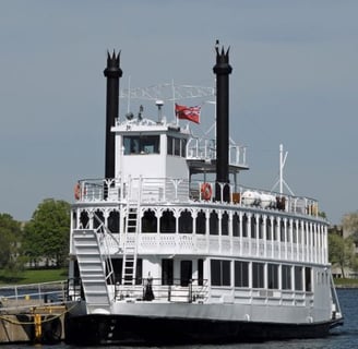 a large white boat with a flag on it