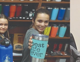 a woman holding drinkware and a woman holding a cake pan