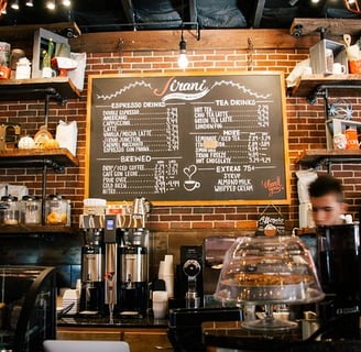 a man is standing in front of a chalkboard with a menu on it