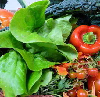 a basket of vegetables and vegetables on a table