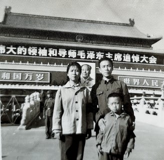 a family posing for a photo in front of a building